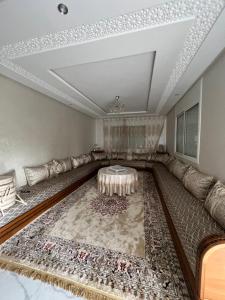 a living room with a couch and a table at Safae in Agadir