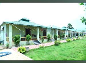 a house with a lawn in front of it at Ak Green View Beach Resorts in Chīrāla