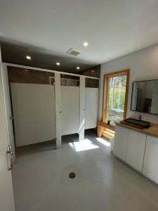 a large room with white doors and a window at Tanières MicroChalets Charlevoix in Baie-Saint-Paul +62 photos