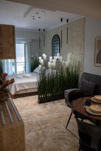 a living room with a bed and some plants at CityView Luxury Suite in Alexandroupoli