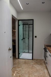 a bathroom with a glass shower in a room at CityView Luxury Suite in Alexandroupoli +20 photos