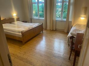 a bedroom with two beds and two windows at Trunnagården in Orsa