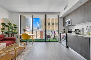 a kitchen and living room with a view of a city at Miami Downtown Bayside Balcony Studio in Miami