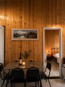 a dining room with a table with wine glasses at Alis House 3 in Batumi