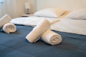 two beds with towels on the floor in a bedroom at Aria garden house in Loborika