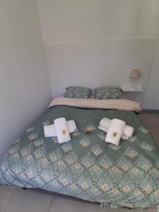 a bed with towels and pillows on it at Santoni House in Ghisoni