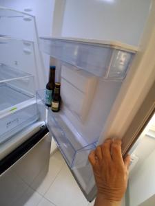 a person is reaching into an open refrigerator at Santoni House in Ghisoni