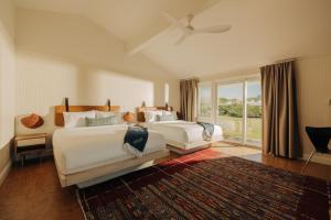 a bedroom with two beds and a large window at Barlume Beach in Montauk