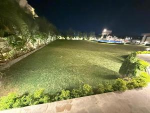 a large field of grass at night with a building at Oryana Resort in Udaipur