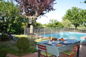 a blue table with chairs next to a swimming pool at Chambre dhôtes au pigeonnier in Poulan-Pouzols +27 photos