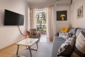 a living room with a couch and a tv at Spartan Gem Apartment in Sparta