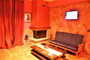 a living room with a couch and a fireplace at Happy Holiday Villa in Siracusa