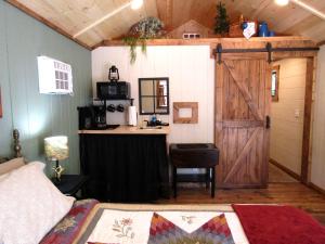 a room with a bed and a door and a desk at Grizzly Gulch Cabin Historic in Keystone