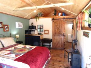 a bedroom with a bed and a wooden ceiling at Grizzly Gulch Cabin Historic in Keystone