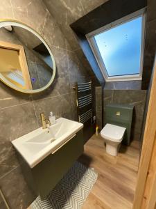 a bathroom with a sink and a mirror and a toilet at Coorie-Tigh in Connel +11 photos