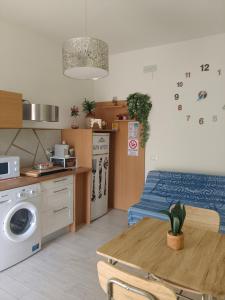 a small kitchen with a table and a bed at l'alba sullo jonio in Taranto +29 photos