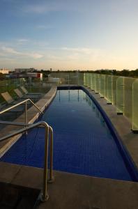 a large swimming pool with blue tiles on a building at Fiesta Inn Mérida Altabrisa in Mérida