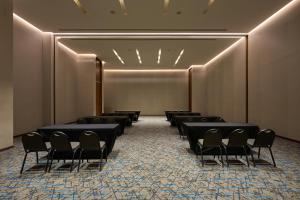 a row of chairs in a room with a wall at Fiesta Inn Mérida Altabrisa in Mérida +28 photos