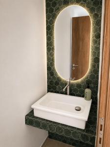 a bathroom with a sink and a mirror at Villa Sofia Traditional Cycladic living in Kampos Paros