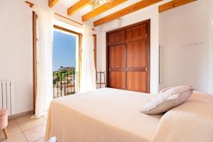 a bedroom with a bed and a large window at Stunning Deià Views & Private Pool in Deia +46 photos