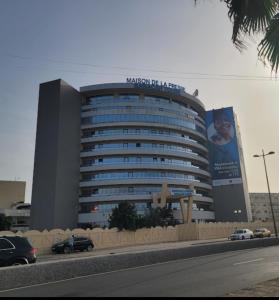 a large building with a sign on top of it at Maison Babacar TOURE in Dakar