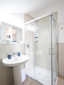 a bathroom with a sink and a shower at Le camere di Gaudré in Battipaglia +29 photos