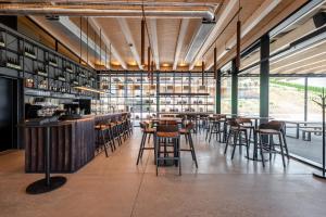 a bar with chairs and tables in a restaurant at ARTEVINI Resort & Winery in Velké Pavlovice