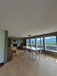 a dining room and living room with a table and chairs at Villa Strand in Skodje