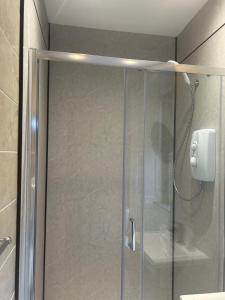 a shower with a glass door in a bathroom at Rowardennan Hotel in Rowardennan +16 photos