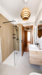 a bathroom with a glass shower and a sink at Kronos House in Torre del Lago Puccini +82 photos