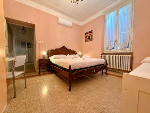 a bedroom with a bed and a large window at La Gardenia del ducato in Parma