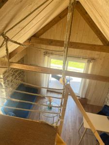 an attic room with a ladder and a window at Ty glaz in Plouguerneau