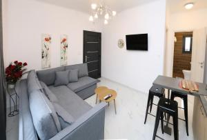 a living room with a couch and a table at VenisHome 2 in Chrysoupolis