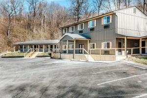 a large building with a parking lot in front of it at Grey Pine Lodge in Waynesboro