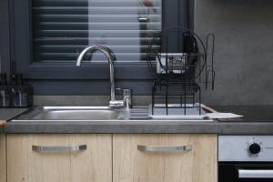 a kitchen sink with a dish drying rack on it at VenisHome 2 in Chrysoupolis +42 photos