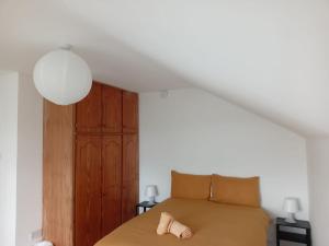 a bedroom with a bed with a wooden cabinet at Comfy Home in Castlebar