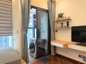 a bathroom with a shower and a television in a room at Mai home in Hai Phong