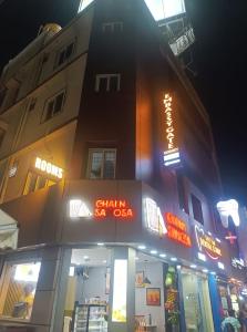 a building with neon signs on the side of it at Embassy Gate Residency - opp US Embassy in Chennai +12 photos