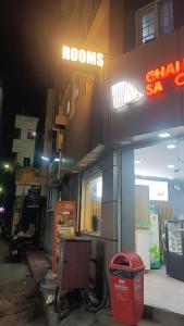 a building with a neon sign on the side of it at Embassy Gate Residency - opp US Embassy in Chennai