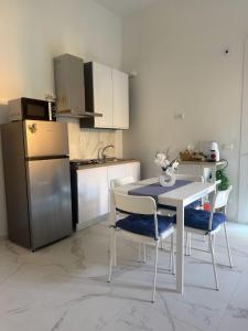a kitchen with a table and chairs and a refrigerator at Angels Venice in Marghera +6 photos