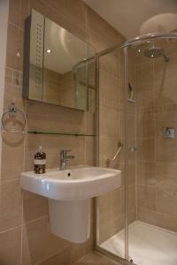 a bathroom with a sink and a shower at Aughamore Home in CBG
