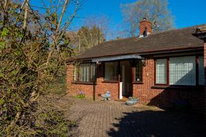 a brick house with a bench in front of it at Aughamore Home in CBG