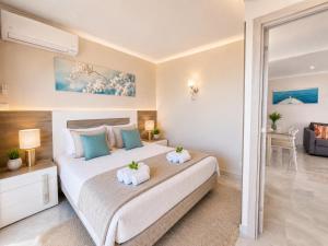 a bedroom with a large bed with two pillows at Luxury Ocean View Apartments I Sunset Terrace I Pool I 200m to Praia dos Três Castelos in Portimão