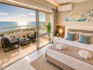 a bedroom with a bed and a view of the ocean at Luxury Ocean View Apartments I Sunset Terrace I Pool I 200m to Praia dos Três Castelos in Portimão