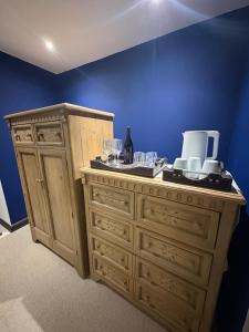 a wooden cabinet with wine glasses on top of it at Marble on 8 in Rustenburg +29 photos