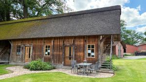 an old wooden house with a table and chairs at Speicher in Soltau in Soltau
