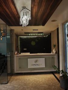 a lobby with a large television and a chandelier at Continento the classic hotel in Malappuram