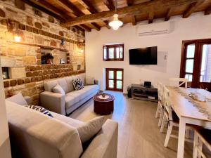 a living room with a stone wall at Twin vista getaway in Meyisti