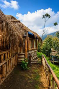an old house with a straw roof at Sholanest Mud House and Farm Stay in Vattavada Near Munnar in Vattavada +21 photos