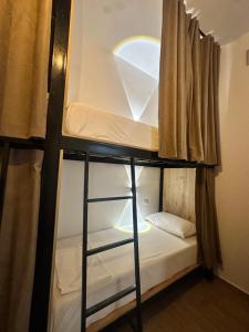 a bunk bed in a room with a window at Bume's Hostel in Sarandë